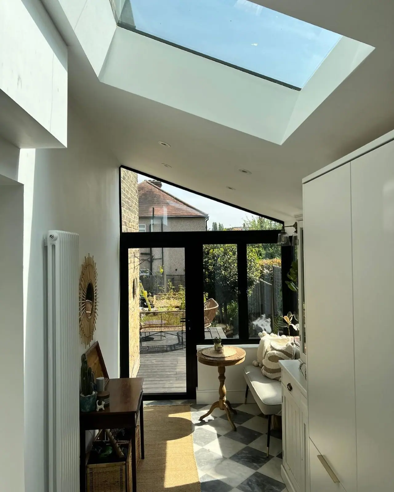 The room rebuilt as a side return, with a solid roof, a roof light and a chequerboard floor